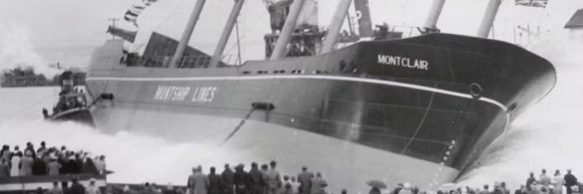 Historic black-and-white image of the ship 'Montclair' being launched into the water, observed by a crowd onshore.
