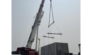 Crane lowering temporary industrial pump station into place.