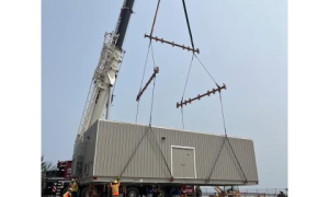 View of crane lowering Temporary Industrial Pumping Station into place