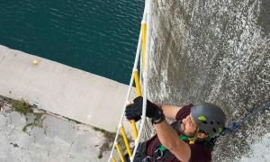 a contestant of the amazing race canada participates in a challenge at the Collingwood Grain Terminals
