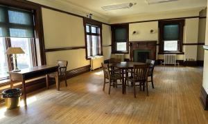 Open room with table, chairs and fireplace